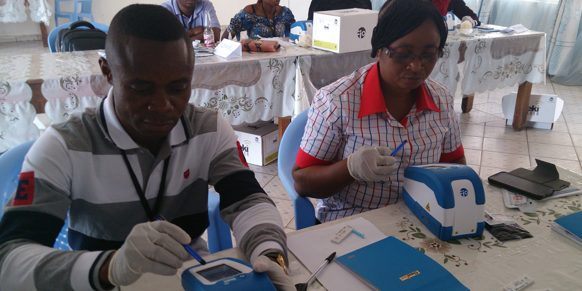 health workers using mobile malaria testing technology