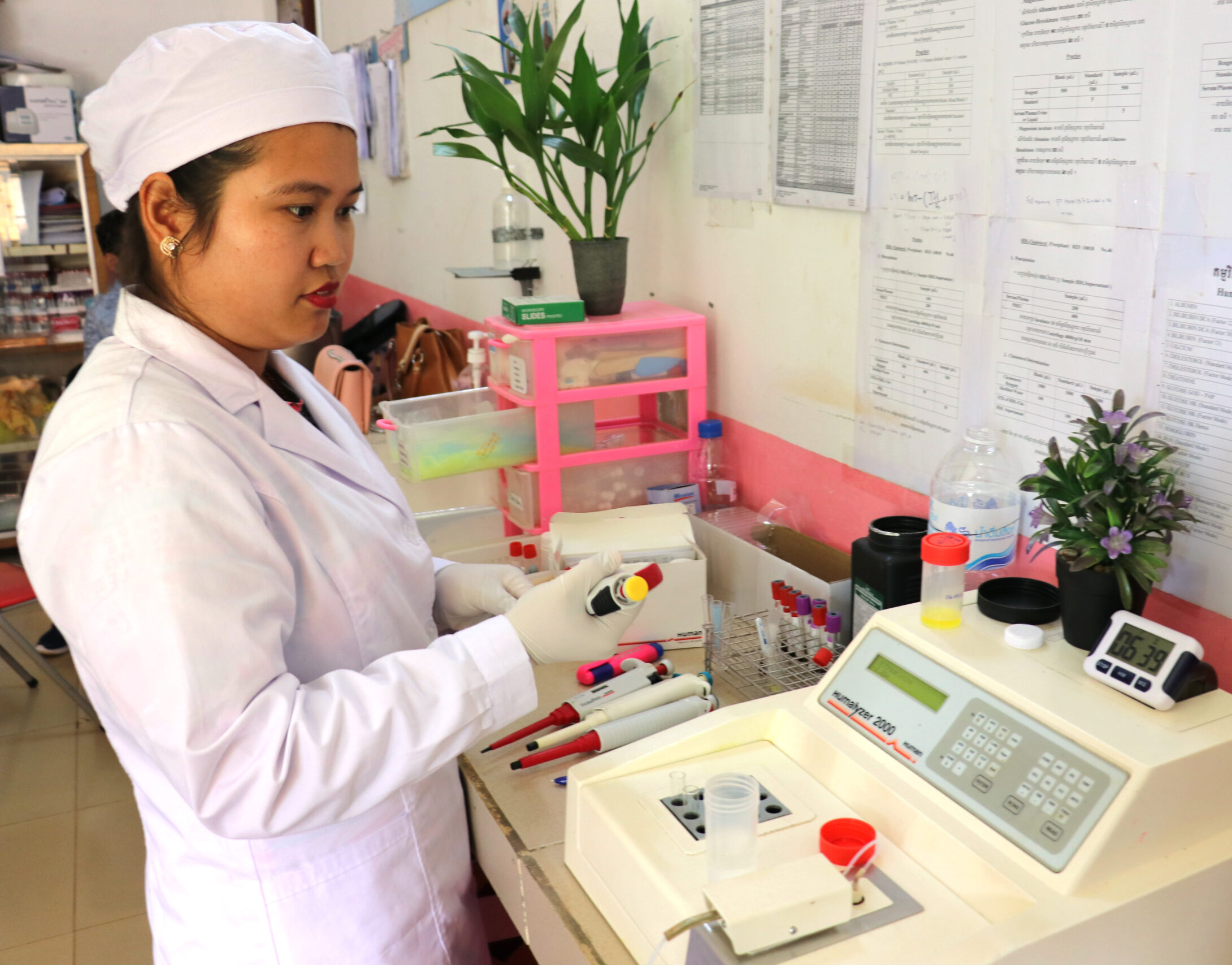 A woman in a lab coat tests samples