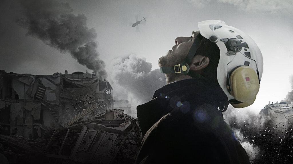 Side profile of emergency worker looking up at a sky filled with smoke