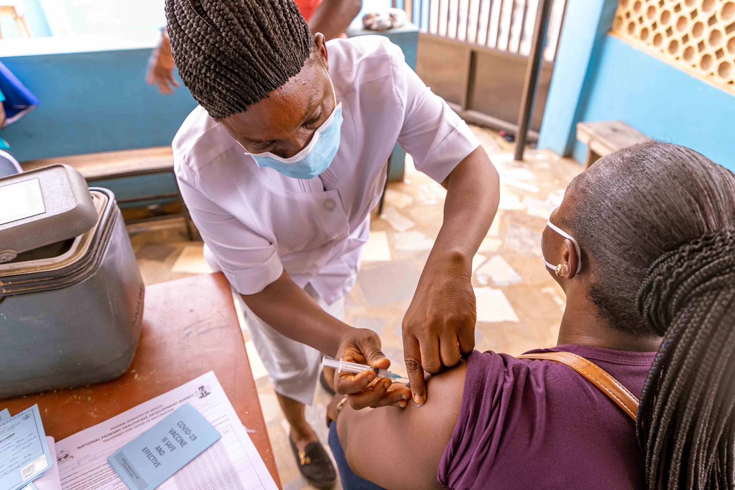A nurse gives a vaccine to a patient